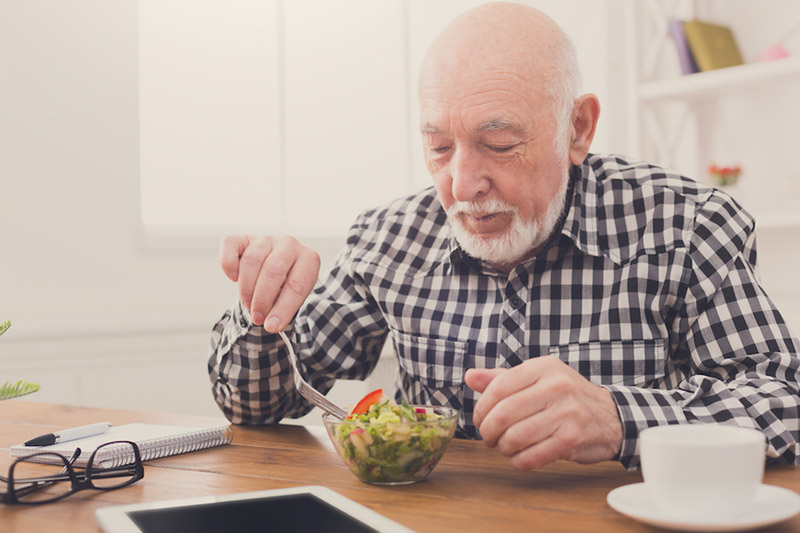 Older man eating a salad