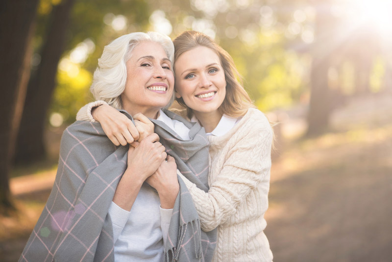 Women and grandmother standing outside in spring