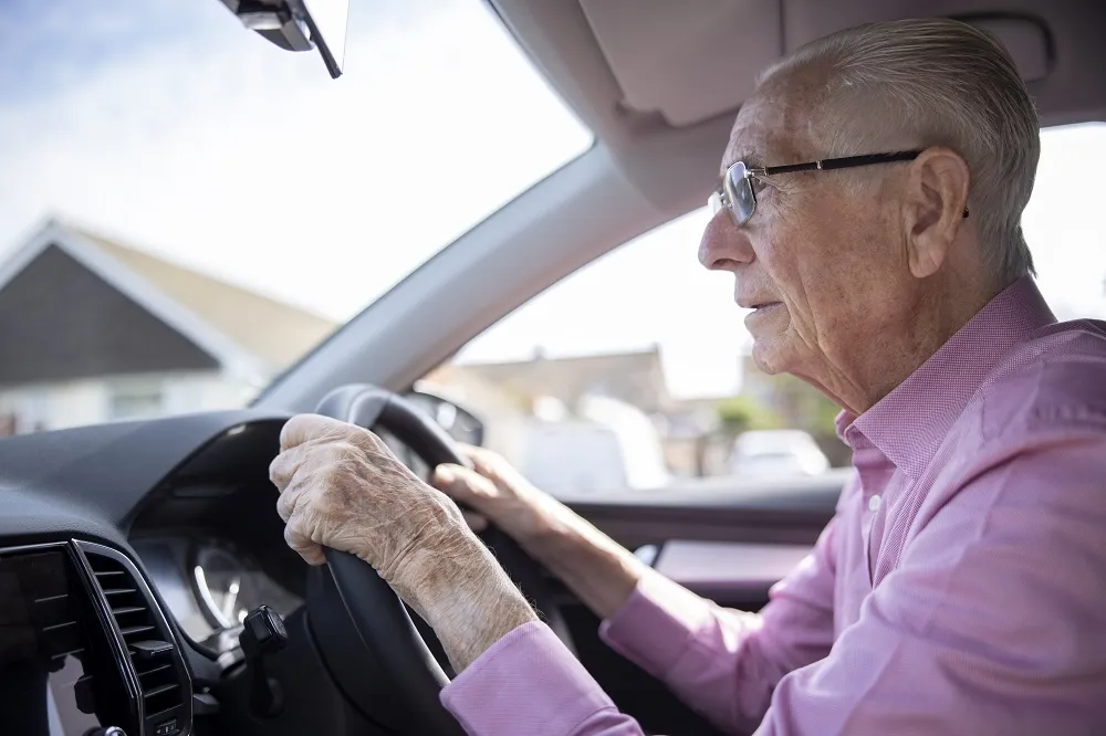 Worried Senior Male Driver Looking Through Car Windscreen